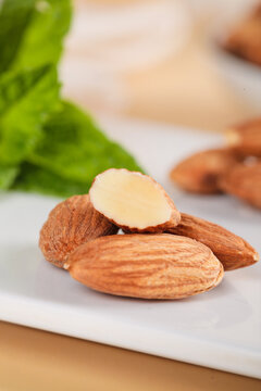 Fresh Raw Almonds with Peeled Almond on White Cutting Board - Healthy Snacking Nuts