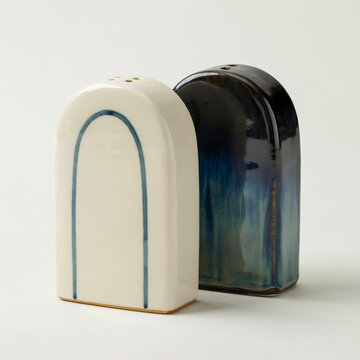 Ceramic salt and pepper shakers cream with blue arch and dark blue glaze side view salt shaker kitchenware