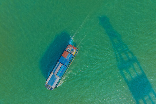 Cargo vessel in green water at Shekou Port, Shenzhen, China