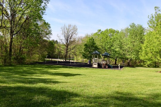 The playground in the park on a sunny day.