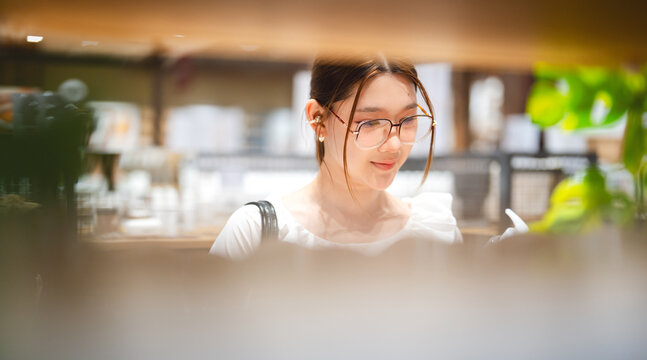Young adult asian woman shopping facial skin care choosing beauty product in retail store japanese business look fashion