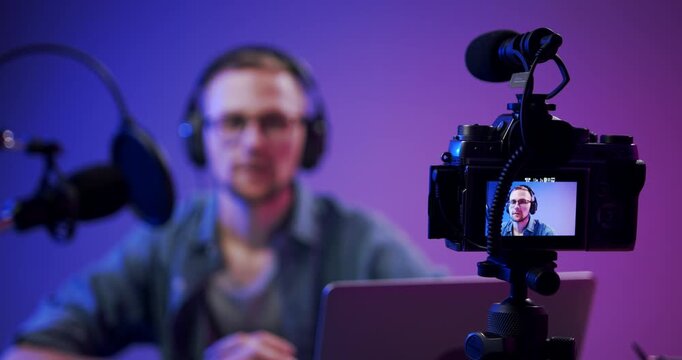 Video production equipment filming a content creator during a live recording session.