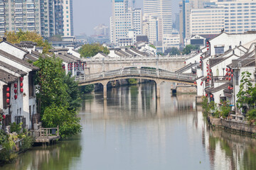 Fototapeta premium Wuxi Liyuan Canal with Traditional Architecture and Modern Skyline, Jiangsu