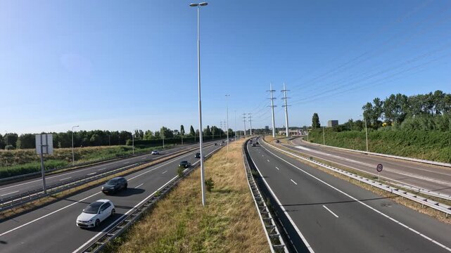Cinematic driving footage on the A4 motorway near Delft in the Netherlands, scenic highway travel and commuter traffic video
