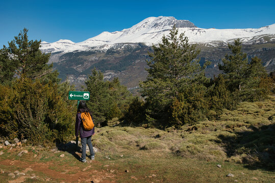 A young girl hiking along the Tella Hermitages Trail in Huesca, located in the Aragonese Pyrenees. Monte Perido and Ordesa