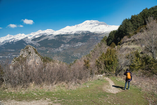 A young girl hiking along the Tella Hermitages Trail in Huesca, located in the Aragonese Pyrenees. Monte Perido and Ordesa