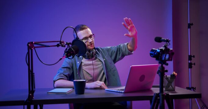 Professional camera recording a podcaster in a modern content creation studio.