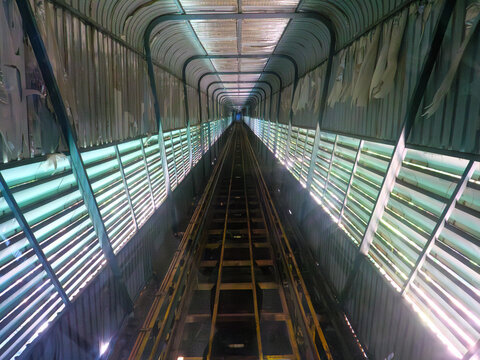 Perspective View of a Long Steel Rail Tunnel Interior