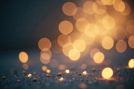 Abstract Dark Background with Warm Golden Bokeh Lights and Small Pebbles on Ground