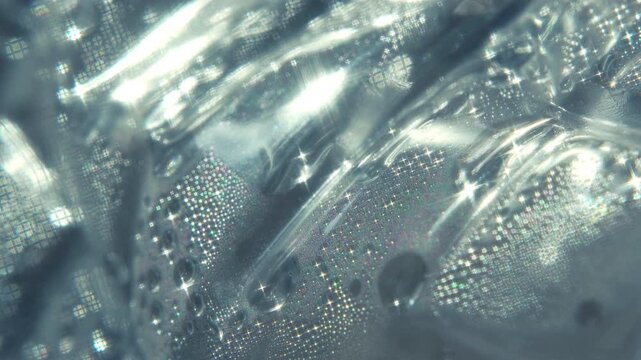 Macro Close-Up of Plastic Water Bottle Texture with Rotating Sparkle Light Effects