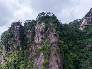 Stunning aerial view of the rocky cliffs and lush green trees at Sanqingshan Mountain in Jiangxi province of China during a bright summer day © AS_SleepingPanda