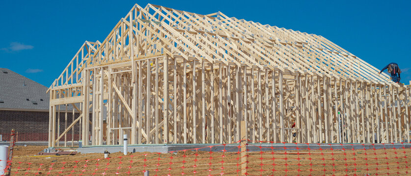Careful construction planning allows rapid housing assembly near Dressage Ln. Visible roof joists indicate progress achieved on project site while clear skies provide ideal conditions. Aubrey, TX