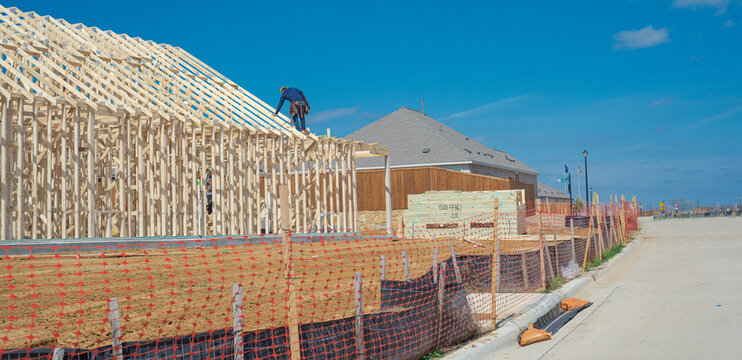 Active residential development landscape extends past Dressage Ln, signaling growth. Lone builder occupies high ridge line while brick dwellings stand finished under bright daylight. Aubrey, TX