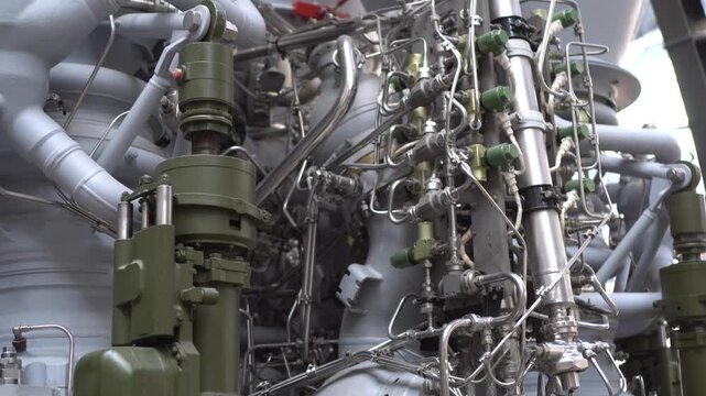 Vintage Soviet rocket engine featuring large propulsion nozzles, metallic surfaces, and industrial engineering details. A symbol of Cold War space achievements and technological innovation in