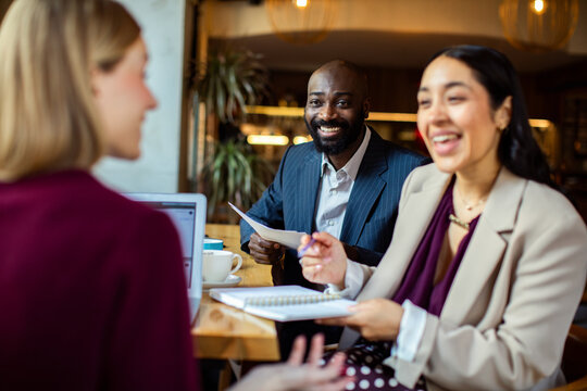 Colleagues having a business meeting in a cafe