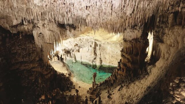 Nature view inside dark dragon cave. Tourist attraction: caves stalactites and stalagmites rock formations blue water lake river. town Porto Cristo Mallorca Spain. vertical video Cuevas del Drach.