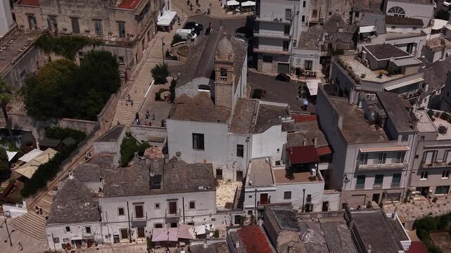Aerial view flying over the beautiful historic architecture of cisternino, a charming old town with white houses and narrow streets in puglia, southern italy