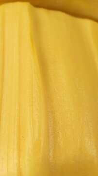 Bright yellow jackfruit pulp circle rotation close up, vertical video format