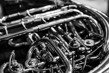 Black and white close-up of French horn rotary valves and brass tubing © Ruslan
