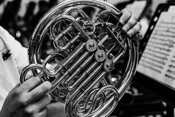 Black and white close-up of French horn rotary valves and brass tubing © Ruslan