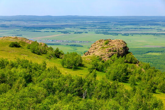 tourists men and women walk along the ridges of the Southern Urals on a summer day. Irendyk ridge