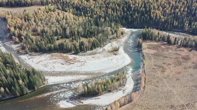 Aerial view of Kanas in autumn with yellow leaves and first snow, Xinjiang, China