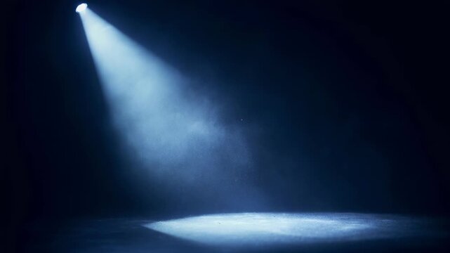 Dramatic spotlight shining on empty dark stage with particles in the air for theater or performance