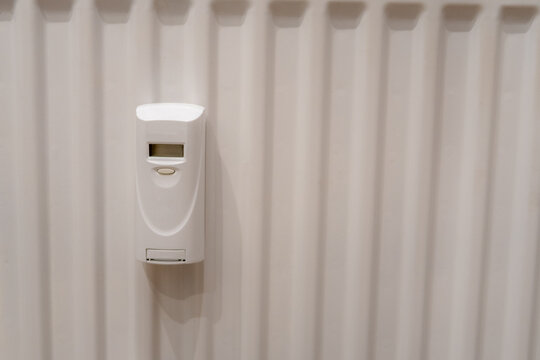 Digital Heat Cost Allocator Mounted on a White Radiator