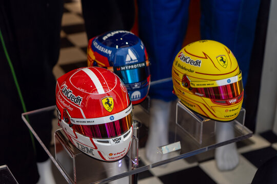 Formula 1 Racing Helmets with Ferrari and Williams Sponsor Logos. Team Shirt. Verona, Italy - June 25, 2026