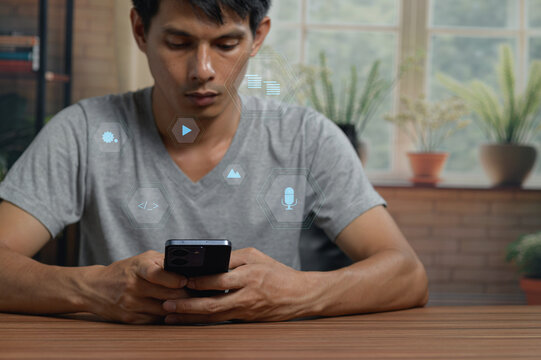 Young Man Using Smartphone with Digital App Icons in Indoor Setting