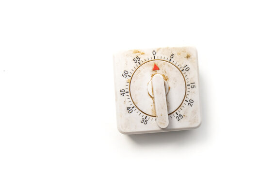 dirty, aged square mechanical kitchen timer with a plastic knob, isolated on a white background.