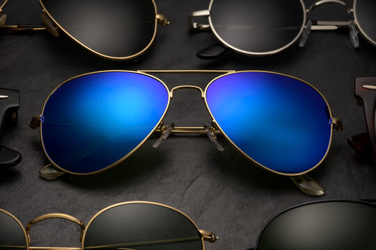 Collection of stylish aviator and round sunglasses.