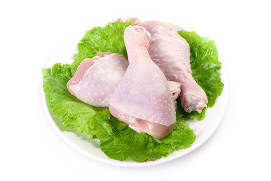 Fresh Raw Chicken Thighs and Legs on Lettuce Leaves