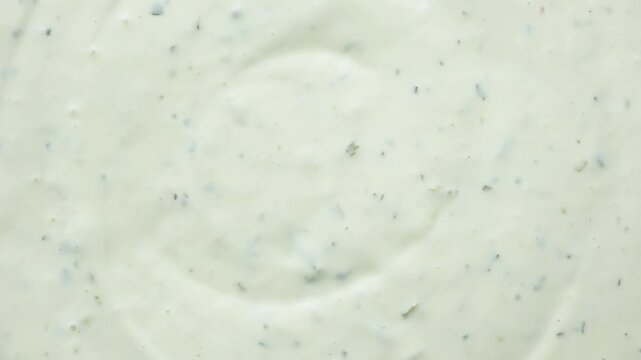 Close-up texture of creamy tartar sauce with herbs top view