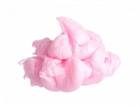Fluffy pink spun sugar confection against a stark white backdrop