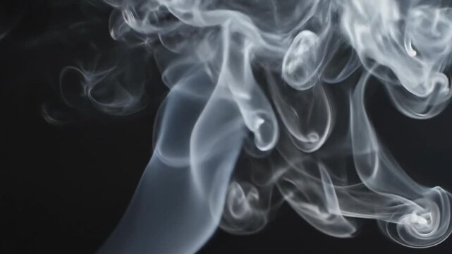 Smoke moves in the dark room creating patterns in the air