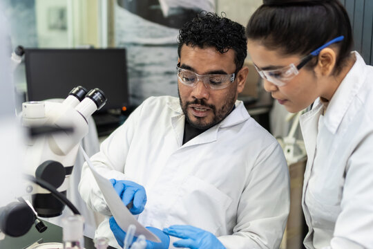 Scientists collaborating in laboratory conducting medical research