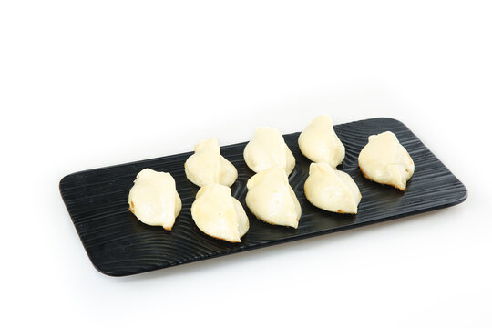 Traditional Chinese Dumplings on Black Wooden Plate - Handmade Shandong Cuisine