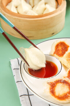 Traditional Chinese Dumplings in Bamboo Steamer with Soy Sauce Dipping - Authentic Asian Cuisine