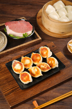 Traditional Chinese Dumplings and Steamed Buns with Fresh Meat on Wooden Serving Boards