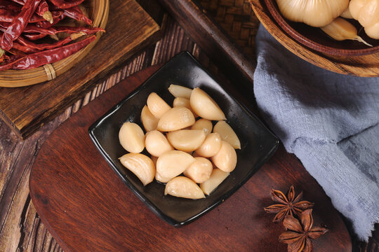 Shandong Style Pickled Sweet Sour Garlic Cloves Traditional Chinese Cuisine Ingredients on Rustic Wood Table