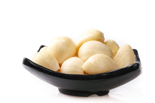 Fresh Peeled Garlic Cloves from Shandong Henan China in Black Bowl White Background