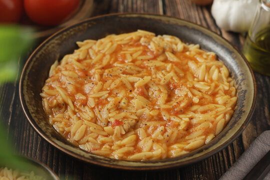 A bowl with traditional Greek soup Manestra with orzo pasta