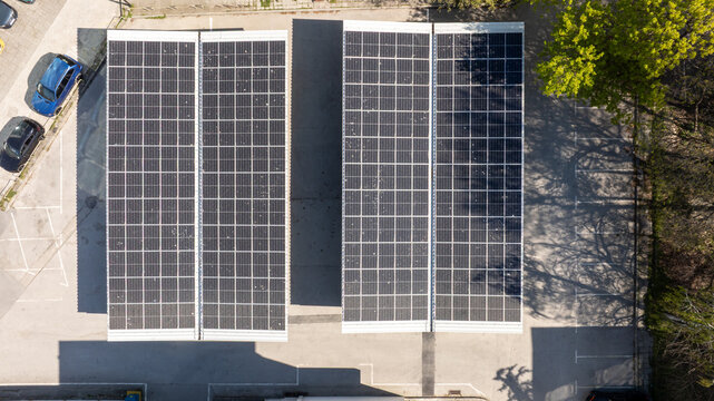 Aerial Top-Down View of Solar Panels on a Parking Lot Carport, Generating Clean Renewable Energy in an Urban Environment