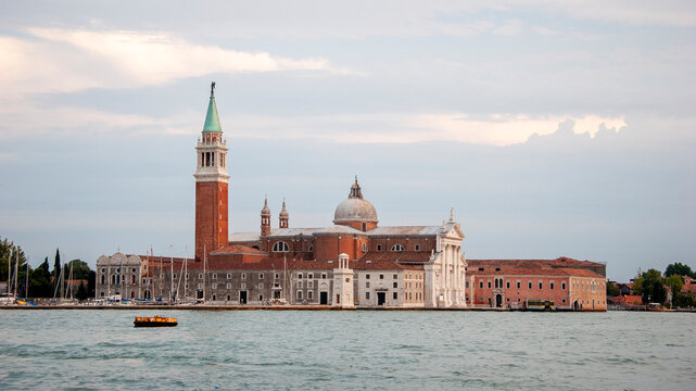 San Giorgio Maggiore island. Soft light over Venetian church and bell tower across calm waters.