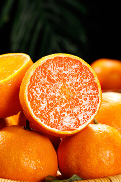 Fresh Orange Halves Showing Juicy Citrus Pulp Texture with Whole Fruits