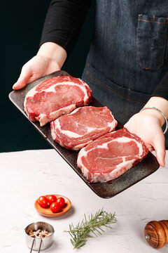Fresh Raw Beef Steaks on Cutting Board - Chef Presenting Premium Meat for Cooking