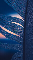 Close-up macro shot of a blue feather with textured strands and a softly blurred sunset background © Mateusz