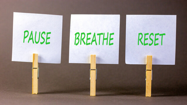 Pause breathe reset words symbol. Concept words Pause breathe reset on beautiful white papers. Beautiful grey background. Business support motivational and pause breathe reset concept. Copy space.