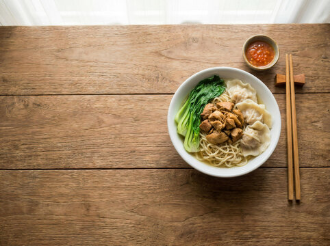 Top View of Asian Chicken Noodle Soup with Dumplings and Blank Copy Space